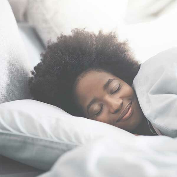 Happy woman resting in bed
